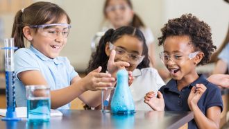 three girls doing a chemistry experiment