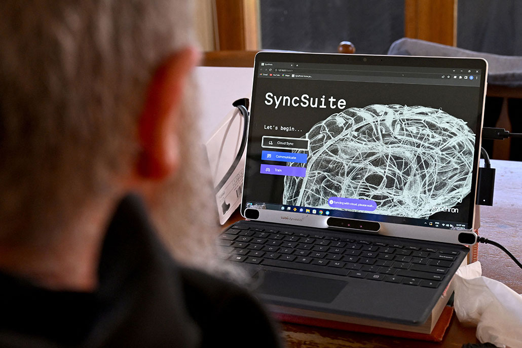 a photo of the back of Rodney Gorhams's head as he looks at a computer running the program that lets his brain implant communicate with his computer